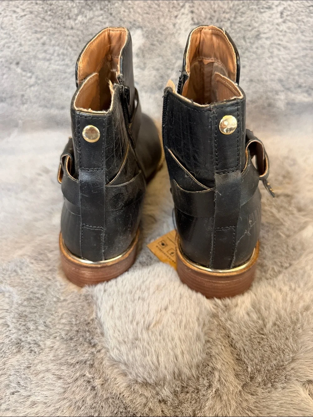 Black leather ankle boots with gold trim